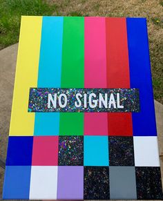 a no signal sign is painted on top of a multicolored piece of paper