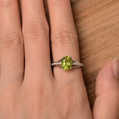 It is a natural peridot ring. The main stone is 7mm*9mm oval cut, weight about 1.99 carats. The basic metal is sterling silver and plated with rhodium. To change the metal to a solid gold (white/rose) or platinum is also available, please ask for a quotation if you want. You can also go to my shop Home for more elegant rings: https://www.etsy.com/shop/godjewelry?ref=hdr_shop_menu More rings: https://www.etsy.com/shop/godjewelry?ref=l2-shop-header-avatar Customization is always welcome and please Lime Green Birthstone Jewelry For Anniversary, Anniversary Lime Green Birthstone Jewelry, Lime Green Jewelry With Accent Stones For Anniversary, Lime Green Jewelry With Accent Stones For May Birthstone, Lime Green May Birthstone Jewelry With Accent Stones, Elegant Lime Green Oval Rings, Oval Peridot Birthstone Ring For May, Dainty Green Oval Birthstone Ring, Oval Peridot Ring In White Gold