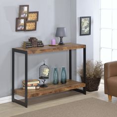 a shelf with books and vases on it in a room next to a lamp