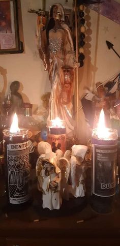 candles are lit in front of a statue