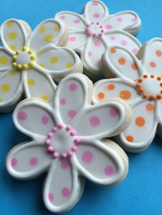 decorated cookies with polka dots and flowers on a blue surface