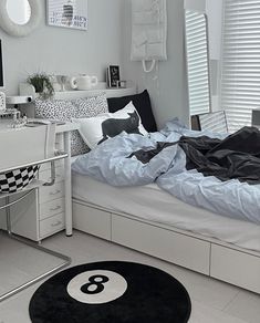 a bed room with a neatly made bed and a desk