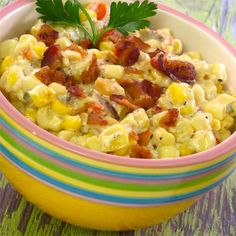 a colorful bowl filled with corn and bacon