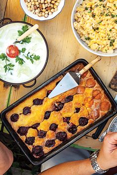 a table topped with plates and bowls filled with different types of food on top of it