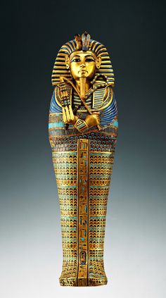 an egyptian statue is shown in gold and blue