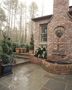 a brick building with potted plants on the outside