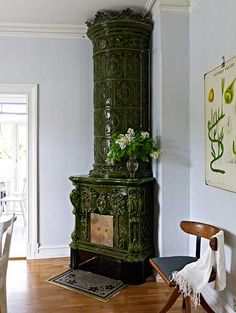 an ornate green cabinet in the corner of a room