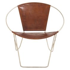 a brown leather chair with metal legs and a round backrest on a white background