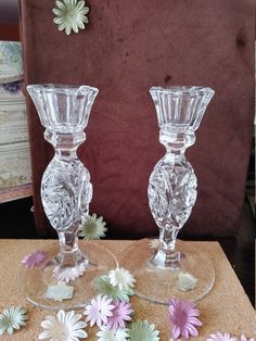 two clear glass vases sitting on top of a table