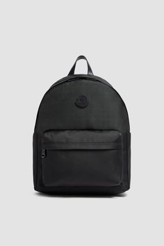 a black backpack on a grey background with the word, logo and two zippers