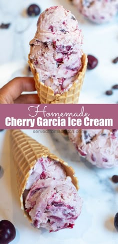 an ice cream cone filled with cherries on top of a white table next to chocolate chips