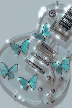 an electric guitar with blue butterflies on it's body and some lights around the neck