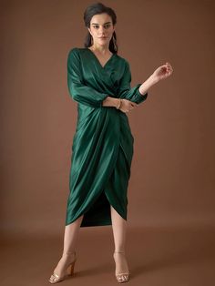 This Collection From VITANS is an ensemble of Outfits designed to make every moment of your evening shimmer with sophistication and style. The collection features luxurious fabrics and exquisite detailing that elevate your evening look to new heights. The collection showcases a palette of deep, rich colors including Emerald Green, Sunset Orange, Nude beiges, velvety blacks, and celestial silvers.The silhouettes are designed to flatter and accentuate, ensuring you feel confident and radiant as yo Festive Evening Dress With Draped Design, Festive Elegant Evening Dress With Traditional Drape, Chic Draped Dress For Festive Season, Chic Draped Festive Dress, Chic Festive Draped Dress, Traditional Drape Satin Dress For Evening, Traditional Drape Satin Evening Dress, Evening Dress With Traditional Satin Drape, Satin Evening Dress With Traditional Drape