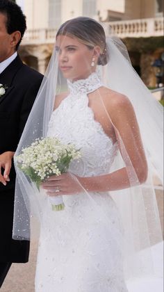 a bride and groom walking down the street