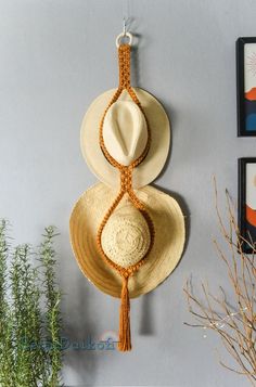 Christmas is just around the corner and these hat hangers are the cutest way to display and store your hats! #macrame #fiberartpassion #macramecommunity #macramehanger #macramehathanger #hathanger #macramedecor #macrameaccessories #macramegifts #handtiedgoods #macrameartist #macramehatband #macramehatholder #macramehatrack Bohemian Beach Fedora In One Size, Bohemian Beach Fedora, One Size, Bohemian Beige Woven Hat, Bohemian Adjustable Beige Mini Hat, Adjustable Bohemian Beige Mini Hat, Bohemian Beige Adjustable Mini Hat, Bohemian Mini Hat With Curved Brim For Beach, Bohemian Crochet Fedora Hat, Bohemian Mini Hats With Short Brim For Vacation