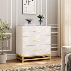 a white and gold chest of drawers in a living room with a plant on top