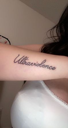 a woman with a tattoo on her arm that says, utilitarianancee