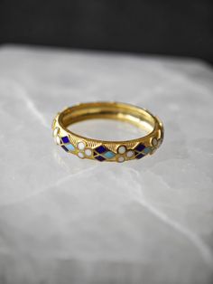 Traditional motifs are commomly used in enamel craftsmanship. We wanted to use an elegant and minimalistic motif on our ring. The ring has four enamel colors : Turquoise, Navy Blue, Black and Ancient White. The ring is 925 Sterling Silver with 18k gold plating. (We do offer different plating options, please see the variations during your purchase.)  If you would like to have your ring with different enamel colors, please message us. We would be so happy to do your custom work. Thank you so much for reading. Victorian Luxury Enamel Ring For Formal Occasions, Heirloom Enamel Ring For Anniversary, Black Enamel Ring For Wedding, Heirloom Black Enamel Ring As A Gift, Heirloom Enamel Ring, Antique Enamel Wedding Ring, Heirloom Enamel Ring Jewelry, Heirloom Black Enamel Ring For Gift, Heirloom Black Enamel Ring Gift