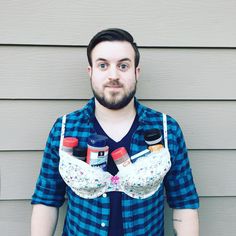 a man wearing an apron and bow tie with bottles in his pockets on his chest