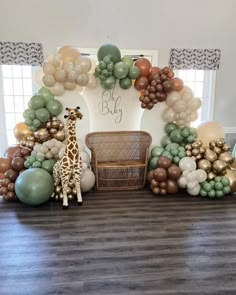 a giraffe is standing in front of some balloons