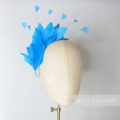 This turquoise feather millinery hat mount is made from trimmed layered goose feathers and delicate diamond shaped stripped coque that spray out from a central wired stem. Simply attach it to a headband to make a simple fascinator or use it to trim up a special hat. Main feather goose feather body length measures around 15-20cm (5.9-7.8 inches)Width: 8-10cm (3-3.9 inches)Length of wired stem: 10cm (3.9 inches)Top tip! This mount comes flat-packed in a clear plastic sleeve. Prepare for use by gen Adjustable Blue Feathered Headpiece, Adjustable Blue Feather Headpiece, Adjustable Blue Mini Hats With Feathers, Beautiful Veil, Goose Feathers, Millinery Hats, Waffle Weave, Paper Lamp, Fascinator