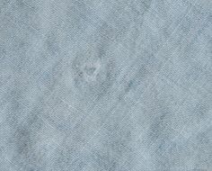 an old blue cloth textured with small holes in the center and on the side