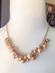 "Beautiful shades of gold pearls are arranged haphazardly along a gold filled chain.  Among the pearls are gold toned rhinestone balls to add a little sparkle to your neckline.  A stunning classic necklace to add to your wardrobe. ::Details:: Pearl neckline is 5\" long Necklace length is 17\" Chain, lobster clasp and wire are gold filled All jewelry purchased comes inside a box and tied with a ribbon.  Ready for gift giving or to treat yourself. For previews and musings, follow me on instagram @bellaluandme Thank you for shopping handmade! http://www.etsy.com/shop/BellaLuAndMe" Elegant Gold Pearl Necklace With Gold Beads, Glamorous Gold Pearl Necklace For Party, Gold Pearl Necklaces With Dangling Beads, Gold Pearl Jewelry With Beaded Chain, Gold Necklaces With Pearl Charm For Party, Gold Pearl Necklace With Gold Beads, Gold Necklace With Pearl Charm For Party, Gold Beaded Pearl Necklace For Formal Occasions, Glamorous Gold Beaded Necklaces