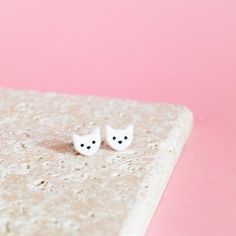 Made as part of our Cat Lady range of jewellery, these kitty earrings have been laser cut from 3mm thick white or black perspex. Adorable, sweet, little cat faces, with handpainted eyes and nose. Perfectly simple, and the best gift ever for a cat lover!Designed and made in the Finest Imaginary studio in the UK.Available in black or white with contrasting features.Made from:Made from 3mm thick white or black perspex, attached to silver plated stud backs with a soft feel closure.Dimensions:The kit Earrings Weird, Weird Earrings, Black Cat Earrings, Funny Earrings, Cat Faces, Best Gift Ever, Cat Lady Gift, Gift For Cat Lover, Quirky Earrings