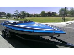 a blue and silver speed boat on trailer