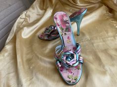 Vintage Betsy Johnson mule shoes, metallic leather multi, floral print.  Super cute!  Ladies size 10M.   You can see how good these look on your feet.  High heels, some wear, overall  good condition. Multi " floral bow" over foot. Slip ons.  Metallic leather upper. Pink, blue, green, gold, blue heels, floral insole.  These are a bit flexible in size, I normally wear around a size 9. Please check measurements to be sure. Insole length:  10 1/2" Foot width:  3 1/2" Heel height:  4 3/4" Vintage Mules Heels, Designer Pink Mules For Spring, Spring Retro High Heel Mules, Designer Floral Print Heels For Spring, 90s Shoes Clogs & Mules, Vintage Open Heel Mules For Summer, Heels Floral, Betsy Johnson Blue Floral Heels, Mule Shoes