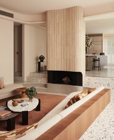 a living room filled with furniture and a fire place next to a wall mounted fireplace