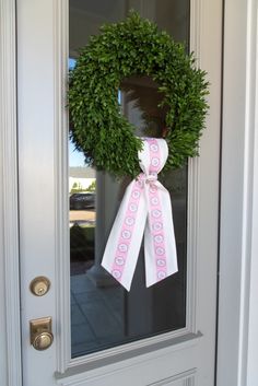 a wreath is hanging on the front door