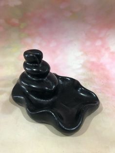 a black candle sitting on top of a table