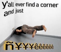 a man laying on the ground in front of a wall with words above it that say y'all ever find a corner and just ny yeeeeeeeeee