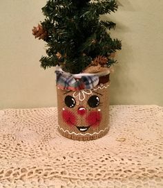 a small potted plant with a face on it sitting on a doily covered table