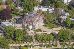 an aerial view of a large mansion surrounded by trees