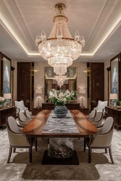 an elegant dining room with chandelier and marble table