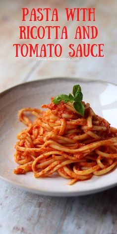 pasta with ricotta and tomato sauce on a white plate