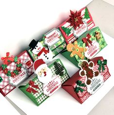 four christmas gift boxes with different designs on them