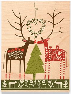 two deer standing next to each other on top of a wooden plaque with trees and leaves