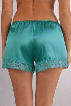 Shorts in light stretch silk satin embellished with a small lace ruffle. Summer Satin Bottoms With Lace Trim, Party Bottoms With Lace Trim And Short Length, Satin Bottoms For Loungewear, Satin Short Bottoms For Loungewear, Satin Loungewear Bottoms Short Length, Satin Shorts For Loungewear, Satin Loungewear Shorts, Satin Lounge Shorts, Sleep Shorts With Lace Trim