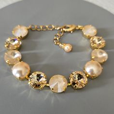 ♡ Genuine Austrian Crystals and Pearls ♡ 12mm round Rhinestones and Pearls ♡ Colors:  Ivory Cream, Ivory Cream Matte, Light Silk, and  Peach Pearls ♡ Gold plated (nickel free) ♡ Adjustable 7" - 9" ♡ Lobster claw clasp ♡ 2" extender chain with Swarovski crystal bead charm ♡ Message me for matching earrings ♡ Handcrafted with love and attention to detail Elegant Beige Jewelry For Formal Occasions, Elegant Formal Beige Jewelry, Elegant Beige Bracelet For Formal Occasions, Elegant Beige Bracelets For Formal Occasions, Elegant Adjustable Cream Pearl Bracelet, Elegant Beige Bracelets, Elegant Cream Pearl Bracelet With Round Beads, Elegant Adjustable Cream Jewelry, Elegant Cream Pearl Beaded Bracelet