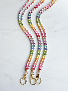 This vibrant teacher lanyard features a delightful mix of colorful beads and natural wood elements. Equipped with a reliable breakaway clasp for safety. Perfect for holding ID badges, keys, or other essentials for easy access. This lanyard is 18.5 inches from breakaway clasps to key ring. Multicolor Lanyards With Key Leash, Multicolor Lanyards With Round Beads And Key Leash, Multicolor Beaded Lanyard With Key Leash, Multicolor Lanyard With Keychain For Everyday Use, Multicolor Lanyards With Key Leash For Personal Use, Multicolor Lanyards With Key Leash For Everyday Use, Multicolor Lanyards With Lobster Clasp For Everyday Use, Everyday Multicolor Lanyards With Keychain, Multicolor Lanyard With Key Leash For Everyday Use