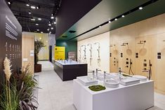 the interior of a store with many sinks and mirrors on display in front of them