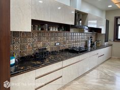 a kitchen with tile backsplashes and wooden cabinetry in the center area