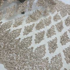 Handmade, high quality Beaded Lace Fabric Embroidered on 100% Polyester Net Mesh. Beautiful on wedding dresses, evening gowns, dance costumes, and more. Content: 100% Polyester / Minimum Order: 1 Yard / Size: Approximately 50" wide / Ships within 24 business hours Colors: This product comes in 4 different colors. Wedding Ball Gown With Sequins And Lace, Lace Ball Gown With Sequins For Wedding, Wedding Lace Ball Gown With Sequins, Lace Wedding Ball Gown With Sequins, Gold Lace Ball Gown For Wedding, Glamorous Fitted Embroidered Fabric For Wedding, Sequin Lace Ball Gown For Debutante Ball, Glamorous Sequin Fabric With Intricate Embroidery For Wedding, Wedding Lehenga Embellished With Lace