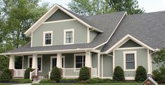 a gray house with white trim and windows