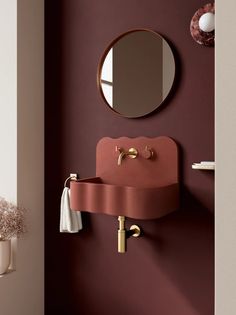 a bathroom with a sink and mirror on the wall next to a vase filled with flowers