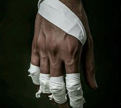 a person's hand with bandages on it