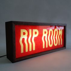 a red and yellow sign that says rip room in gold lettering on the side of it